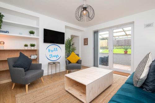 a living room with a couch and chairs and a tv at Super King Bed Free Parking Alexa Garden Patio BBQ Sleeps 5 in Avonmouth