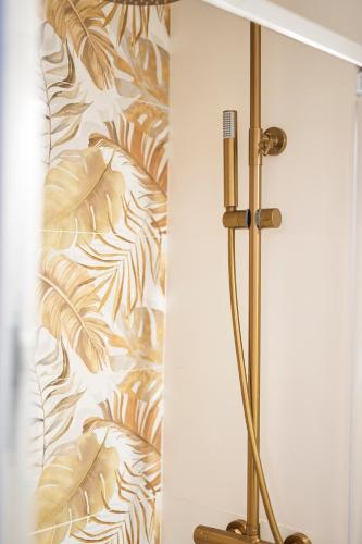 a shower in a bathroom with a wall at La Casita de Helen in Ronda