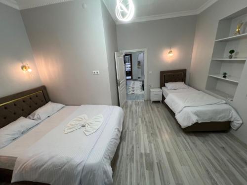 two beds in a room with white sheets at Sultanahmet Blue Suites in Istanbul