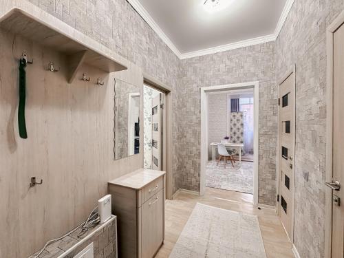 a bathroom with a sink and a mirror at Евродвушка в ЖК Ирина in Pavlodar