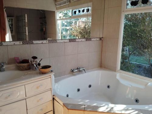 a large bath tub in a bathroom with a window at Algarrobo cercano a la playa, en lugar tranquilo ,rodeado de naturaleza in Algarrobo