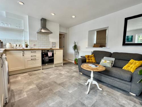 a living room with a couch and a table at Wothorpe House, 4 bed, Stamford Centre by Belmont Places in Lincolnshire