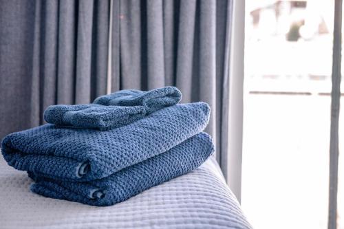 a pile of towels sitting on top of a bed at The LOVE Boat! -An OBX Floating Getaway- in Manteo
