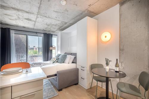 a living room with a couch and a table at Urban Hideout - Downtown Haven in Montréal