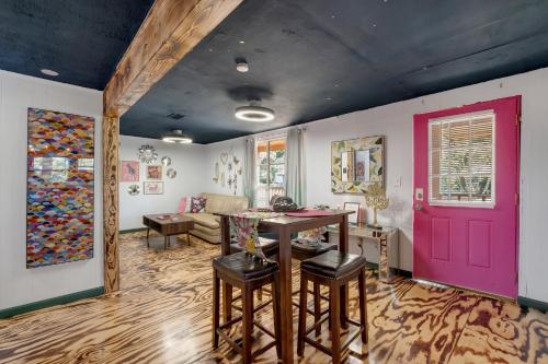 a room with a pink door and a table and chairs at Artsy 2BR, Near FSU & Downtown in Tallahassee