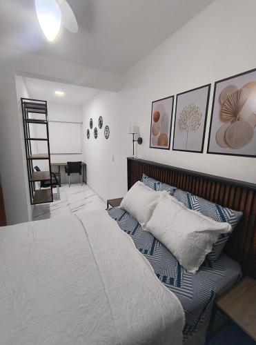 a bedroom with a bed with a ladder and pictures on the wall at Lindo Apartamento em condomínio in Itatiba