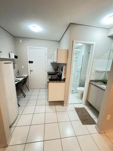 a kitchen with a sink and a toilet in it at Travellar Spot 1317A in Ribeirão Preto