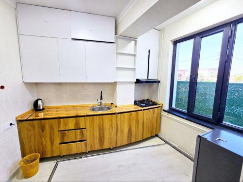 a kitchen with a sink and a large window at New Apartment in Tashkent in Tashkent