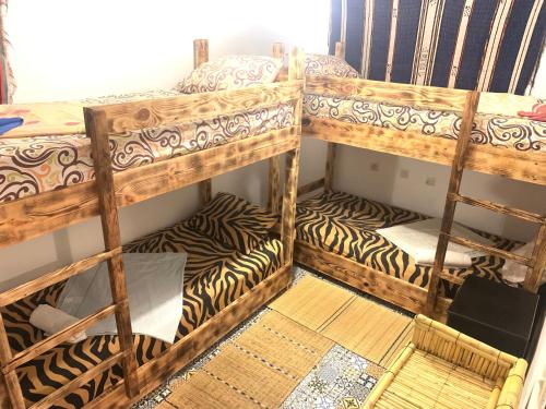a room with two bunk beds in a room with at Surf & Skate in Taghazout