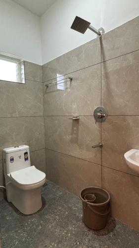 a bathroom with a toilet and a sink at MistAura Vagamon Tea Garden Cottage in Vagamon