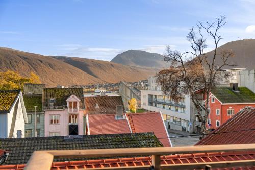 a view of a town with mountains in the background at Central loft apartment, with a view from the roof terrace in Tromsø