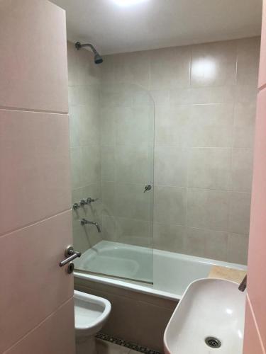 a bathroom with a shower and a tub and a sink at Comen 4 pican 5!! in Buenos Aires