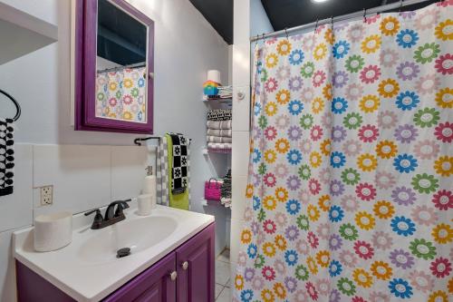 a bathroom with a shower curtain with a sink at 1 Mile To Fsu-artsy Tree-house in Zion Hill