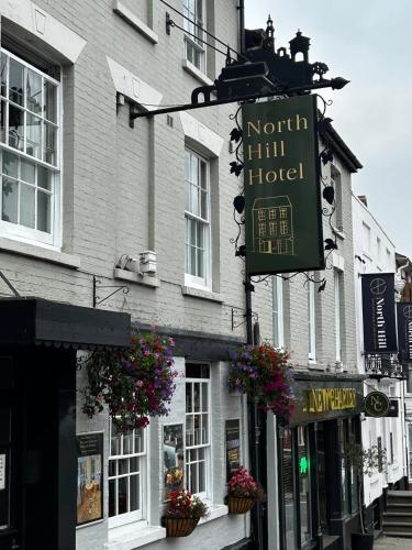 a building with a sign for a hotel on a street at The North Hill Hotel, Colchester in Colchester