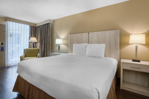 a large white bed in a hotel room at Best Western Battlefield Inn in Manassas