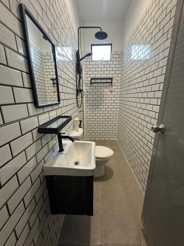 a bathroom with a sink and a toilet at Zar House With Swimming Pool in Malacca