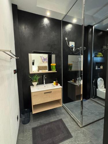 a bathroom with a sink and a shower at ThiThi's Palace Mirissa in Mirissa