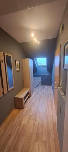 an empty room with a room with a wooden floor at FeWo Spelle in Spelle