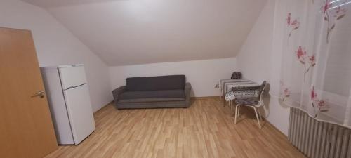 a living room with a couch and a refrigerator at FeWo Spelle in Spelle