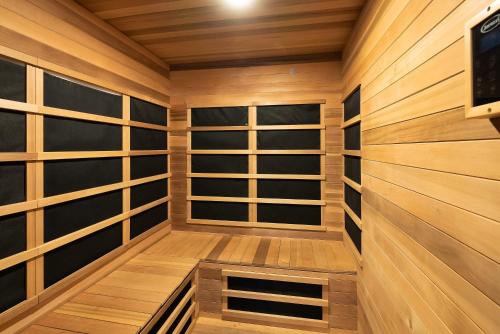 a sauna with wooden walls and wooden shelves at Updated Downtown home next to NAU in Flagstaff