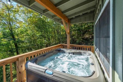 a hot tub on the deck of a house at Mountain Views Hot Tub Family Room & Game Room in Swiss
