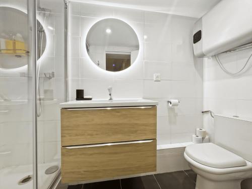 a bathroom with a toilet and a sink and a mirror at Convinient souplex basement 5mn near métro and Montmartre in Paris