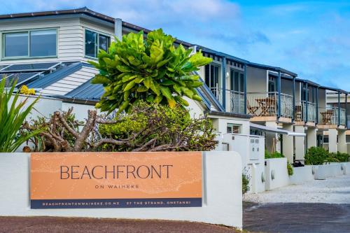 a beachfront on water apartments sign in front of a building at Beachfront on Waiheke in Onetangi