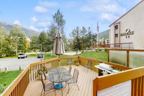 a balcony with a table and an umbrella at Summit House East 112 in Copper Mountain