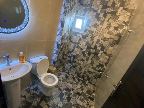 a bathroom with a toilet and a sink and a shower at Chalet 101 - Zresidence - Faitroun in Al ‘Aqabah