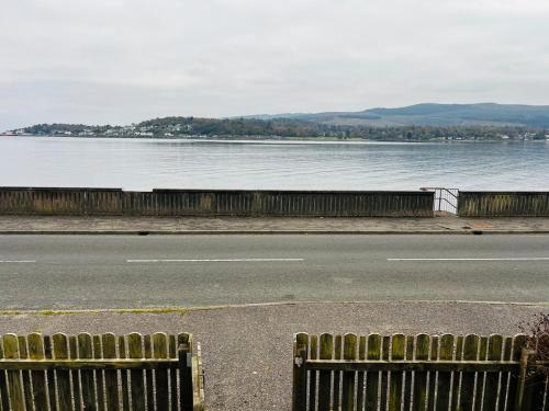 a view of a road and a body of water at Angel Cottage, Strone in Dunoon