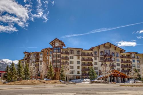 a large apartment building with a clock tower at Passage Point 215 in Frisco