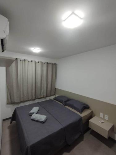 a bedroom with a large bed with blue sheets at Ap Praia do Frances in Marechal Deodoro