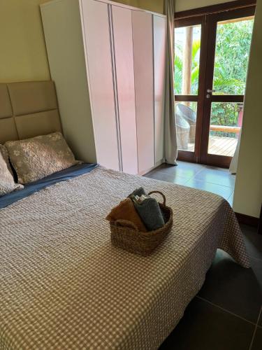 a basket of towels sitting on top of a bed at Itacimirim Beach House in Camacari