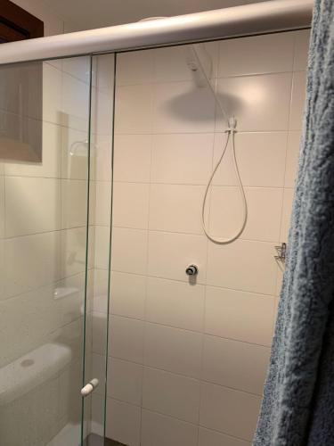 a shower with a glass door in a bathroom at Itacimirim Beach House in Camacari