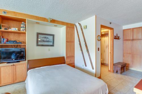 a bedroom with a bed and a flat screen tv at Iron Horse Studio in Winter Park