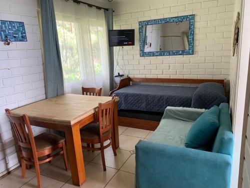 a bedroom with a bed and a table and a couch at Departamento Frente al Mar in Concón