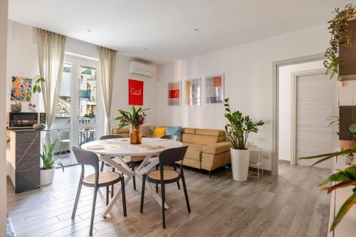 a living room with a table and chairs and a couch at Pomodoro House in Milan