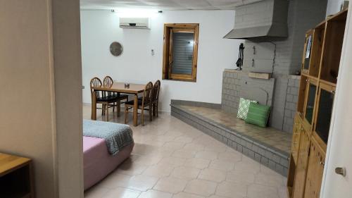 a kitchen with a table and a dining room at casa vacanza con terrazza in Laterza