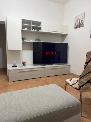 a living room with a tv and a chair at Casa Di Francia in Pontedera