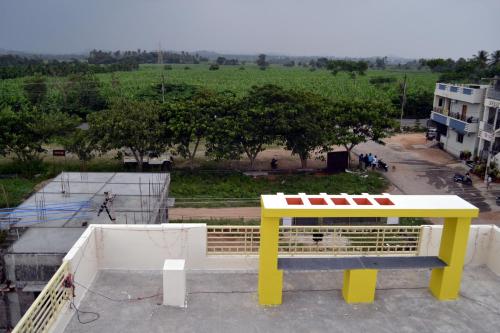 a yellow bench sitting on top of a building at shankar guest house in Hampi
