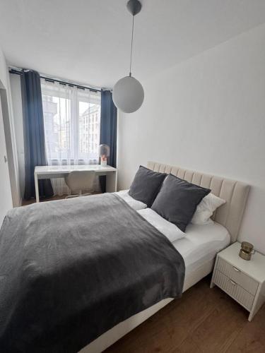a bedroom with a large bed and a window at Modern City Apartment 1 in Munich