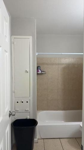a bathroom with a toilet and a bath tub at Mike's home in Texas City