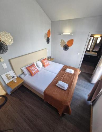 a bedroom with a large bed and a wooden table at Blue Orange Porto Apart in Porto