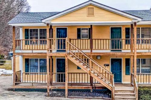 a large wooden house with a large deck at Cozy Ludlow Escape in Ludlow