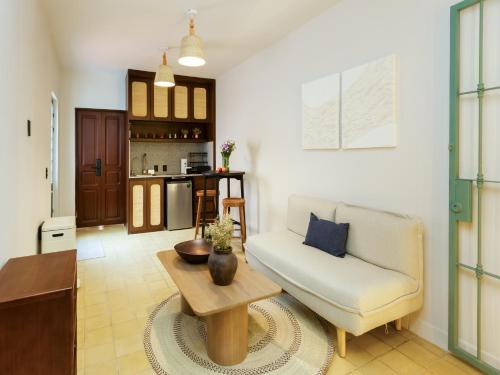 a living room with a couch and a table at Hotel Libertad 1416 in Guadalajara