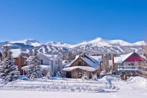 a town covered in snow with mountains in the background at Los Pinos #D10 in Breckenridge