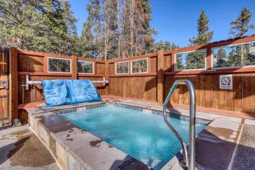 a swimming pool with a wooden fence and a wooden at Los Pinos #D10 in Breckenridge