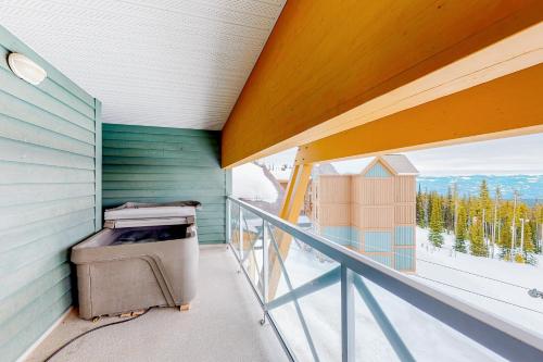 a balcony with a trash can on the side of a house at Hilltop Hideaway - Legacy 401AB in Big White