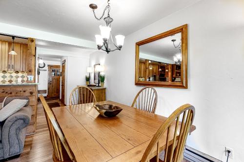 a dining room with a wooden table and a mirror at 613 Tamarack in Moose Wilson Road