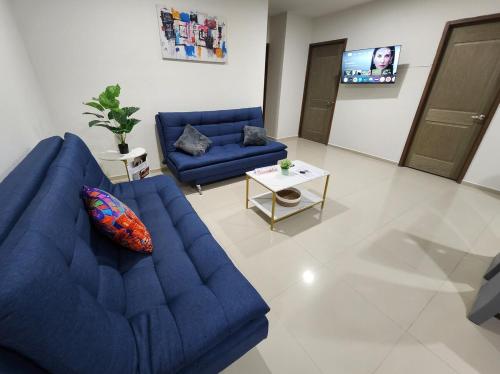 a living room with a blue couch and a table at Downtown Durango, Ground Floor, Spacious and Comfortable Apartment in Durango